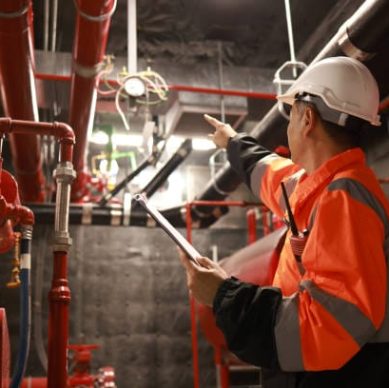The engineer inspects the safety equipment on the fire extinguishing system.